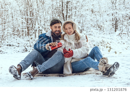 Happy young couple in the winter forest feeling excited and enjoyed 131201876