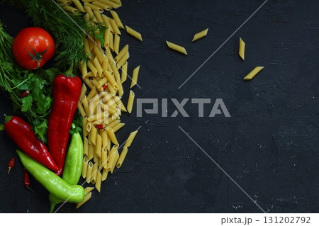 Pasta ingredients on black table, italian cuisine concept 131202792