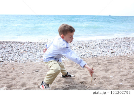 little cute boy playing on beach, lifestyle people concept 131202795