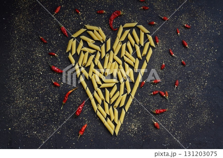 Pasta in the shape of a heart on a black background. 131203075