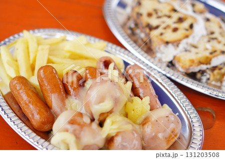 ソーセージとフライドポテトにチーズをかけたボリューム満点の洋風グルメ料理のクローズアップ写真 ソーセージとフライドポテトにチーズをかけたボリューム満点の洋風グルメ料理のクローズアップ写真 131203508