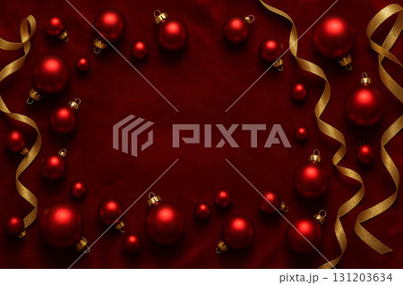 Red background with golden baubles and holiday ornaments creating festive decorative frame. 131203634
