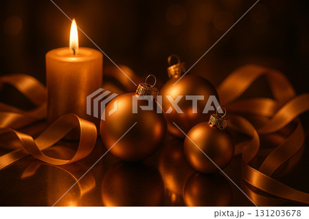 Golden baubles and ornaments with glowing candle on dark festive background. Golden baubles and ornaments with glowing candle on dark festive background. 131203678