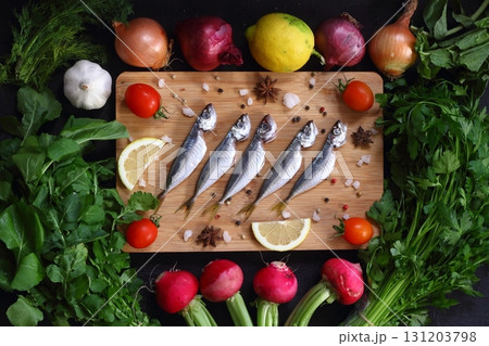 Fresh fish horse mackerel with onion, garlic, tomato, pepper, radish, parsley, arugula and lemon Fresh fish horse mackerel with onion, garlic, tomato, pepper, radish, parsley, arugula and lemon 131203798