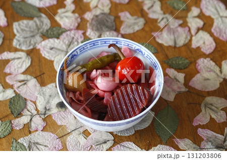Red pickled cabbage in white bowl on wooden background Red pickled cabbage in white bowl on wooden background 131203806