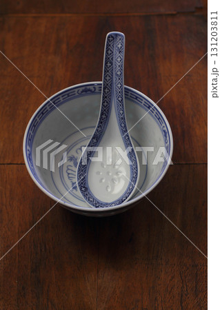 Empty white ceramic bowls on wooden background 131203811
