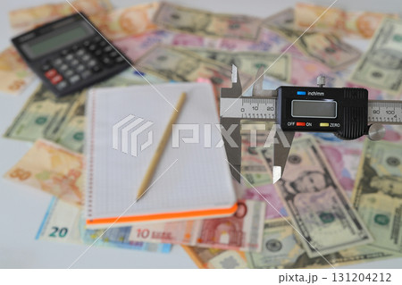 Turkish Lira banknotes of various color, pattern and value on white background With caliper. Selective focus. 131204212