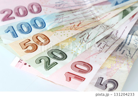 Turkish Lira banknotes of various color, pattern and value on white background 131204233