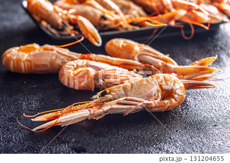 Scampi langoustine on black table. Scampi langoustine on black table. 131204655