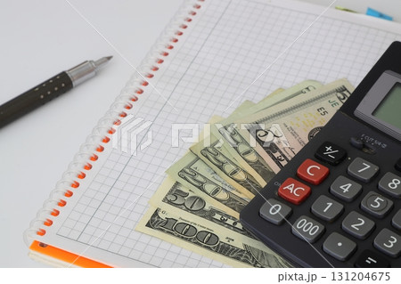 Calculator and dollars isolated on white background Calculator and dollars isolated on white background 131204675