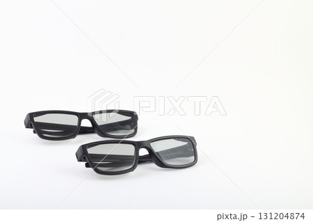 Two pairs of 3d glasses for cinema. Watching movie in 3d. Black glasses on white background 131204874