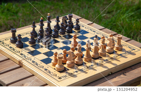 Chessboard with Chess Pieces on Table 131204952