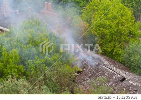 Warehouse fire with smoke and flames from roof 131205918