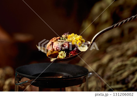 Various dried herbs and spices in old spoon. 131206002