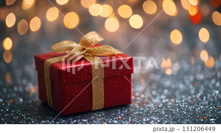 red gift box with golden blurred festive light background 131206449