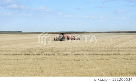 Tractor on Farmland After Harvest 131206534