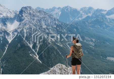 Woman Standing on Mountain Summit in Albanian Alps Woman Standing on Mountain Summit in Albanian Alps 131207234