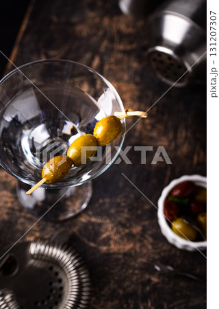 Traditional martini cocktail with olives and 131207307