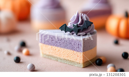 Halloween-themed dessert slice featuring layers of purple, orange, and green, topped with a bat decoration, perfect for festive celebrations 131208301
