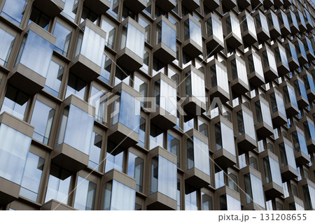 Detailed view of modern building with reflective windows and geometric design, ideal for topics related to contemporary architecture, construction, and city development Detailed view of modern building with reflective windows and geometric design, ideal for topics related to contemporary architecture, construction, and city development 131208655