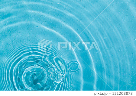 drops on water with circles on a blue background 131208878