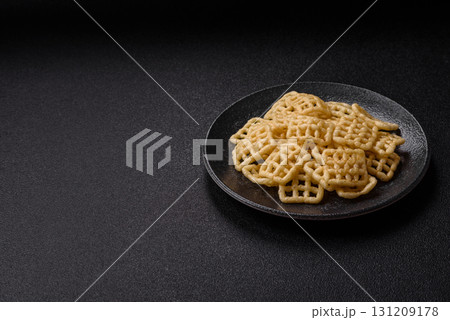 Lattice or wafer potato chips, crispy yellow snacks, takeaway food 131209178