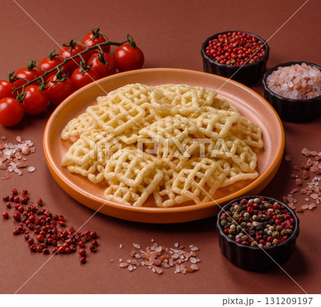 Lattice or wafer potato chips, crispy yellow snacks, takeaway food Lattice or wafer potato chips, crispy yellow snacks, takeaway food 131209197