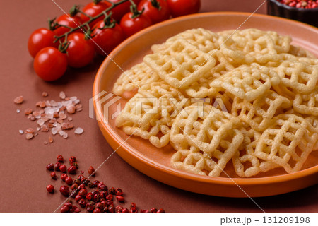 Lattice or wafer potato chips, crispy yellow snacks, takeaway food 131209198