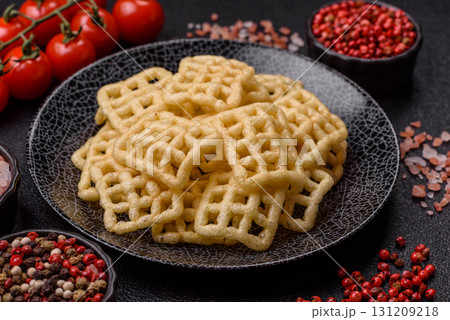 Lattice or wafer potato chips, crispy yellow snacks, takeaway food 131209218