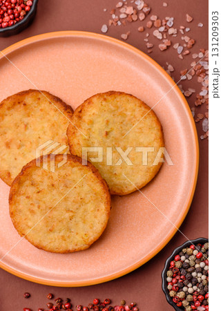 Hash browns, a breakfast food made of potatoes, onions and vegetables. Hash browns with potatoes 131209303