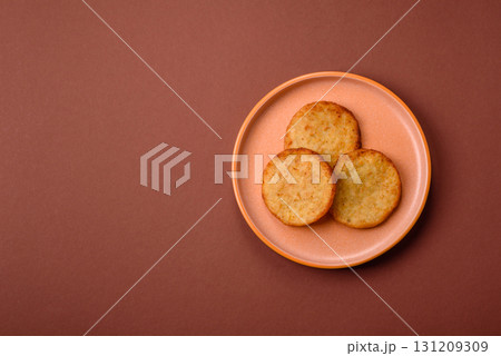 Hash browns, a breakfast food made of potatoes, onions and vegetables. Hash browns with potatoes 131209309