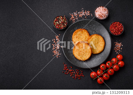 Hash browns, a breakfast food made of potatoes, onions and vegetables. Hash browns with potatoes 131209313