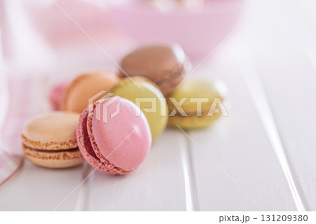 Different flavors of macarons. Colourful macaroons on white table. Different flavors of macarons. Colourful macaroons on white table. 131209380