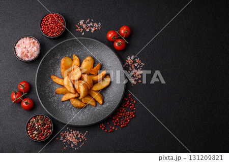 Grilled potato wedges with rosemary, cheese, salt and spices. Baked potato slices 131209821