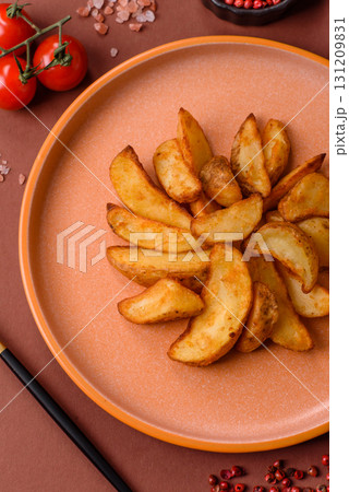 Grilled potato wedges with rosemary, cheese, salt and spices. Baked potato slices 131209831