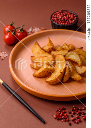 Grilled potato wedges with rosemary, cheese, salt and spices. Baked potato slices Grilled potato wedges with rosemary, cheese, salt and spices. Baked potato slices 131209832