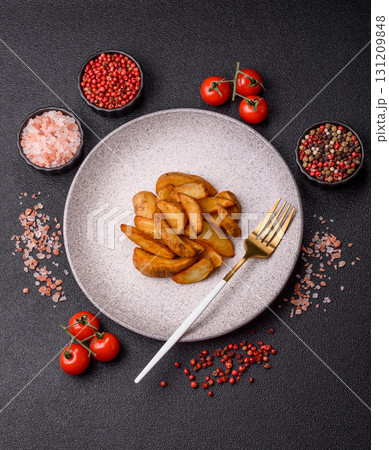 Grilled potato wedges with rosemary, cheese, salt and spices. Baked potato slices Grilled potato wedges with rosemary, cheese, salt and spices. Baked potato slices 131209848
