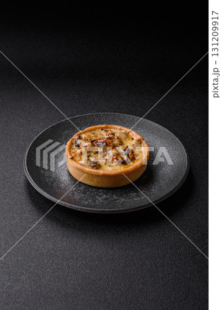 Pie or quiche, a sour tart with chicken and mushrooms, spices and herbs. Round quiche with chicken 131209917