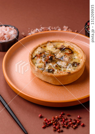 Pie or quiche, a sour tart with chicken and mushrooms, spices and herbs. Round quiche with chicken 131209935