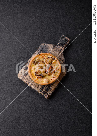 Pie or quiche, a sour tart with chicken and mushrooms, spices and herbs. Round quiche with chicken Pie or quiche, a sour tart with chicken and mushrooms, spices and herbs. Round quiche with chicken 131209945