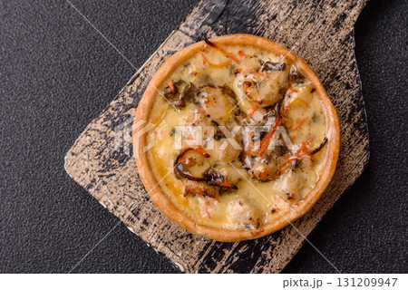 Pie or quiche, a sour tart with chicken and mushrooms, spices and herbs. Round quiche with chicken 131209947