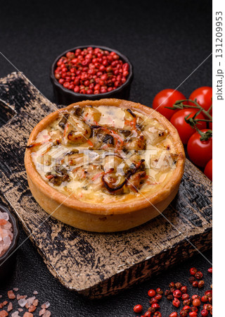 Pie or quiche, a sour tart with chicken and mushrooms, spices and herbs. Round quiche with chicken Pie or quiche, a sour tart with chicken and mushrooms, spices and herbs. Round quiche with chicken 131209953