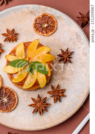 Sweet round pie or tart with apples and peach. Mini sweet tart 131209967