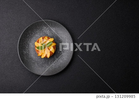 Sweet round pie or tart with apples and peach. Mini sweet tart 131209985
