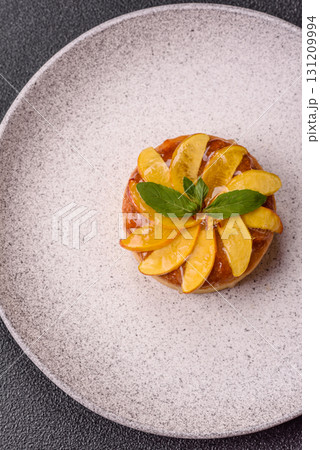 Sweet round pie or tart with apples and peach. Mini sweet tart 131209994