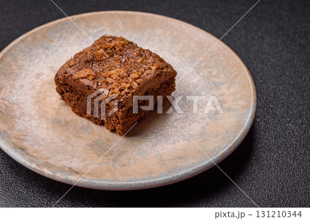 Chocolate brownie cake, food, sweet dessert with nuts rectangular shape. Sweet chocolate brownie 131210344