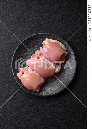 Raw chicken thigh fillet without skin and bone with salt and spices. Raw chicken fillet for cooking 131210518