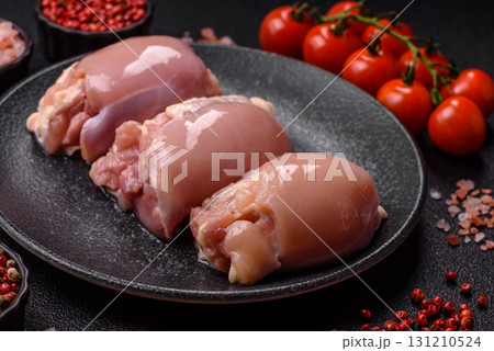 Raw chicken thigh fillet without skin and bone with salt and spices. Raw chicken fillet for cooking 131210524