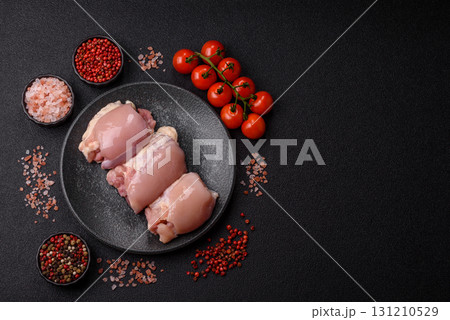Raw chicken thigh fillet without skin and bone with salt and spices. Raw chicken fillet for cooking 131210529