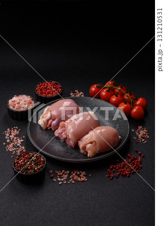 Raw chicken thigh fillet without skin and bone with salt and spices. Raw chicken fillet for cooking Raw chicken thigh fillet without skin and bone with salt and spices. Raw chicken fillet for cooking 131210531